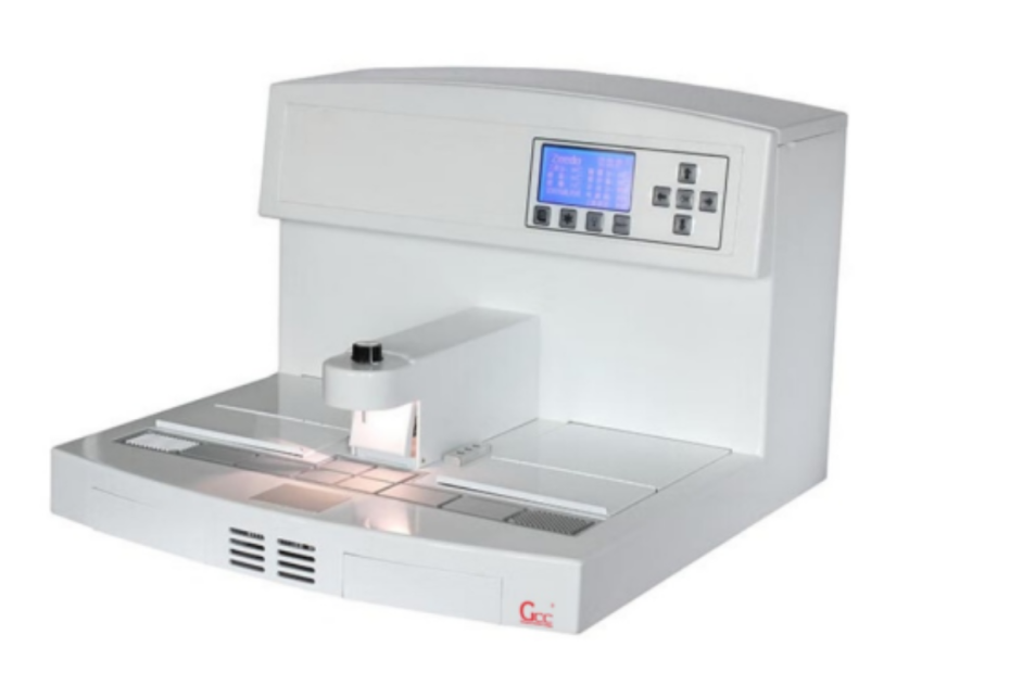 A histotechnologist using a modern embedding station to orient a tissue sample in a paraffin mold, with the heated wax reservoir and cooling plate visible