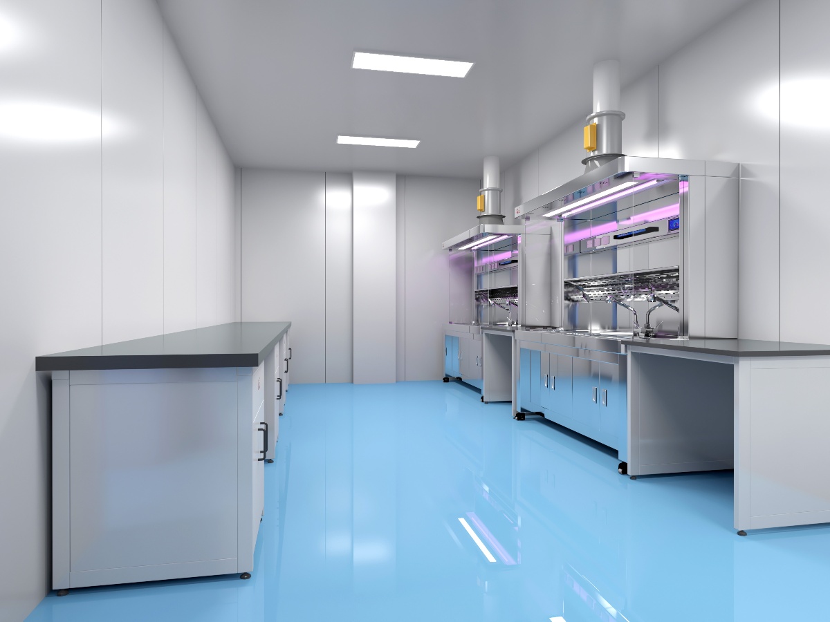 A modern university research laboratory with scientists working at modular workstations, using fume hoods and advanced digital equipment in a bright, well-ventilated space.