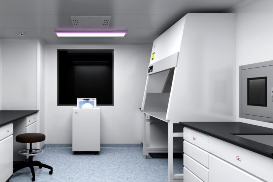Modern pathology laboratory interior with technicians operating hematology analyzers and tissue processors in a full diagnostic workflow.