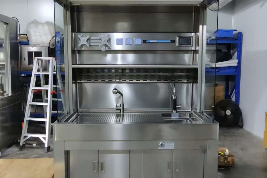 Pathology grossing station showing stainless steel work surface with integrated ventilation and ergonomic design